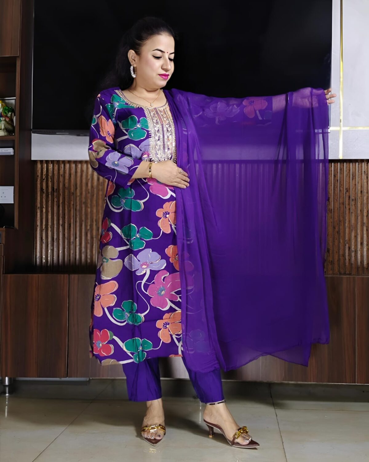 Woman wearing purple silk blend floral print suit with embroidered neckline and matching dupatta