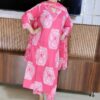 Woman wearing pink cotton floral print suit set with matching dupatta