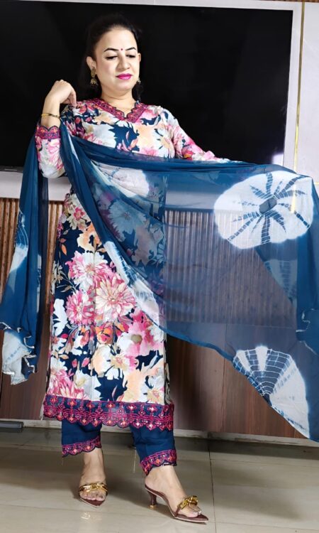 Traditional Indian cotton suit set featuring floral kurta, embroidered pants, and stylish dupatta