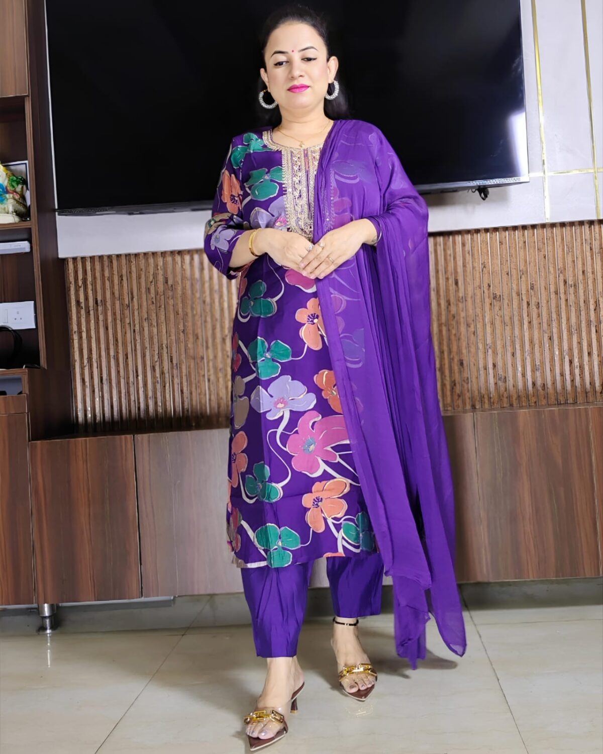 Woman wearing purple silk blend floral print suit with embroidered neckline and matching dupatta