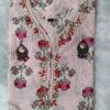 Woman wearing elegant white and pink floral Cambric Cotton suit set with kurta, printed pant, and dupatta – ethnic wear for women.