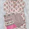 Woman wearing elegant white and pink floral Cambric Cotton suit set with kurta, printed pant, and dupatta – ethnic wear for women.
