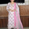 Woman wearing elegant white and pink floral Cambric Cotton suit set with kurta, printed pant, and dupatta – ethnic wear for women.