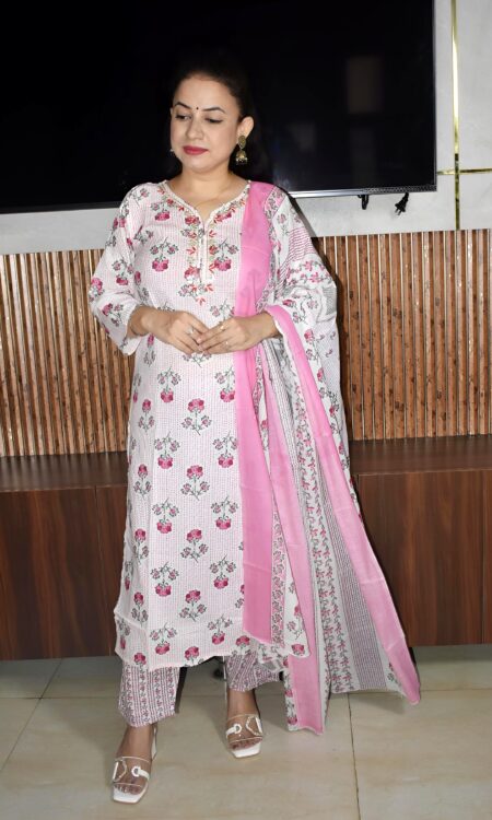 Woman wearing elegant white and pink floral Cambric Cotton suit set with kurta, printed pant, and dupatta – ethnic wear for women.
