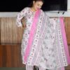 Woman wearing elegant white and pink floral Cambric Cotton suit set with kurta, printed pant, and dupatta – ethnic wear for women.