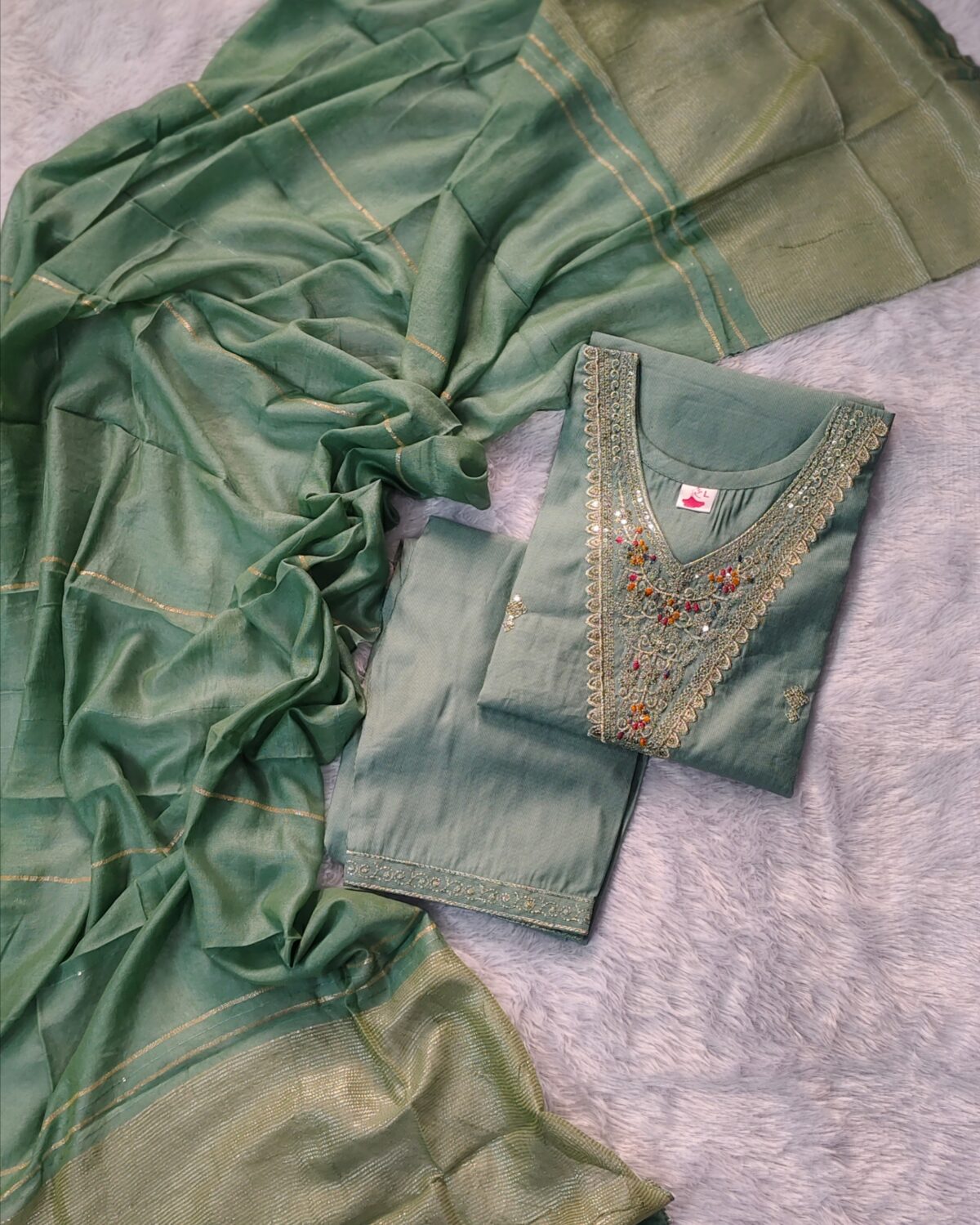 Elegant green Vatican fabric suit set with embroidered V-neck kurta, straight pants, and silk-finish dupatta