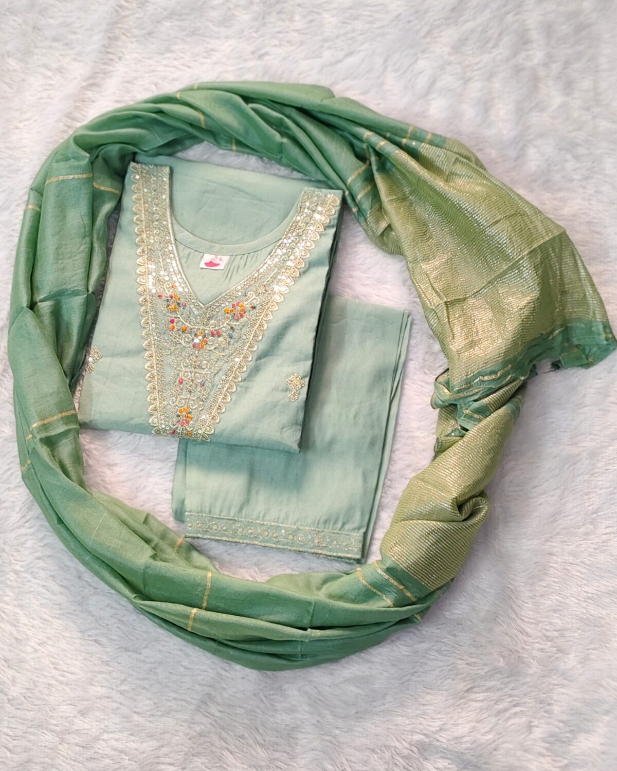 Elegant green Vatican fabric suit set with embroidered V-neck kurta, straight pants, and silk-finish dupatta