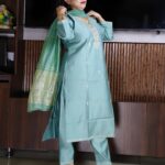 Elegant green Vatican fabric suit set with embroidered V-neck kurta, straight pants, and silk-finish dupatta