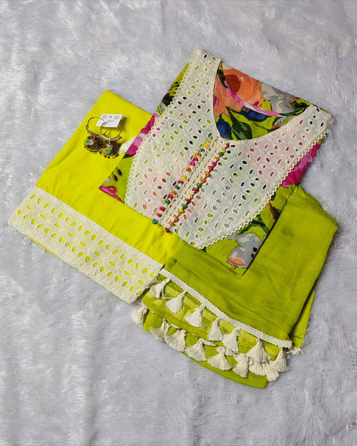 Woman wearing vibrant yellow floral printed salwar suit with lace details and chiffon dupatta