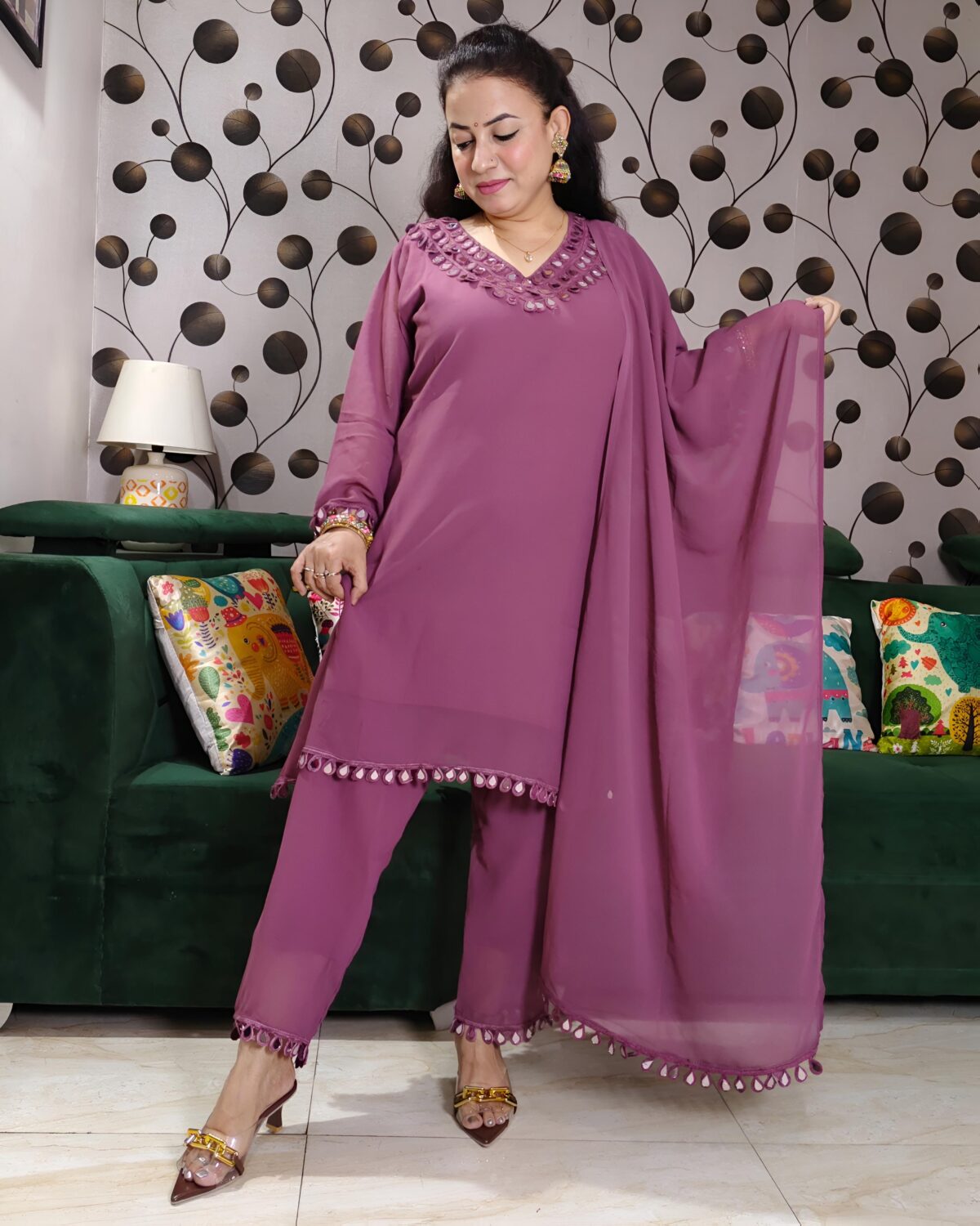 Woman wearing elegant purple mirror work suit with matching pants and dupatta