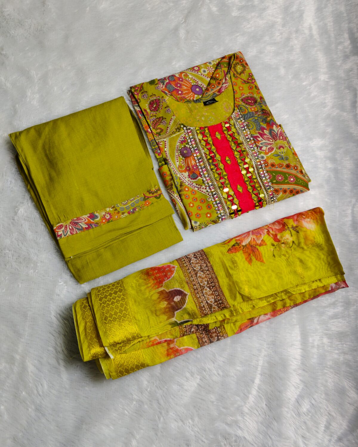 Yellow silk kurta set with paisley embroidery, mirror work, and matching floral dupatta – Indian festive outfit