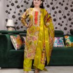 Yellow silk kurta set with paisley embroidery, mirror work, and matching floral dupatta – Indian festive outfit