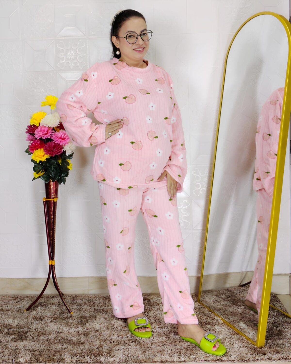 woman wearing blue printed winter fleece night suit with floral and fruit pattern