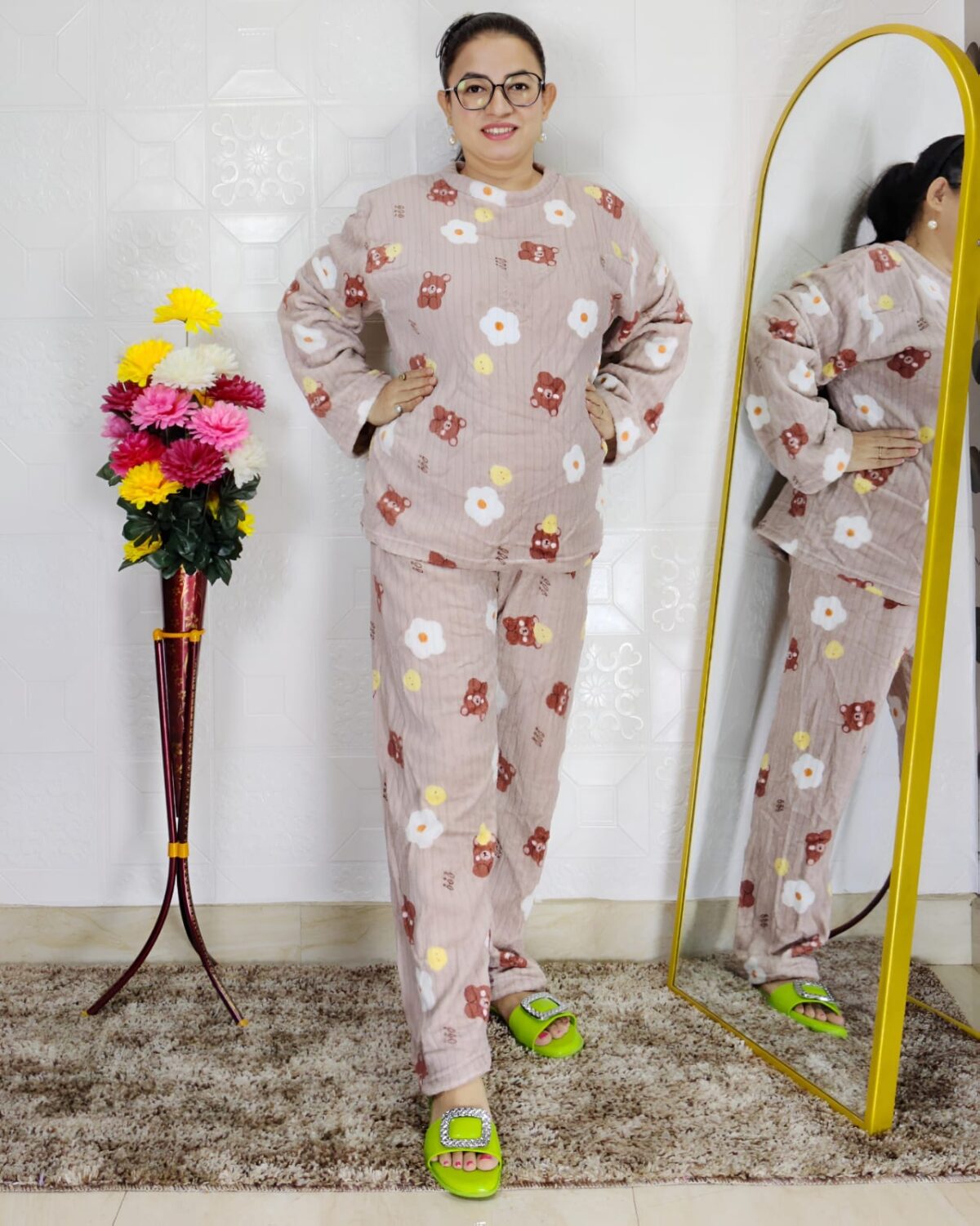 woman wearing blue printed winter fleece night suit with floral and fruit pattern