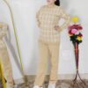 Woman wearing a black and white premium knitted co-ord set with a geometric patterned top and solid black pants