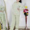 Woman wearing a black and white premium knitted co-ord set with a geometric patterned top and solid black pants