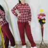 Woman wearing a black and white premium knitted co-ord set with a geometric patterned top and solid black pants