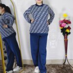 Woman wearing a maroon and white premium knitted co-ord set with a geometric patterned top and solid maroon pants