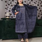 Woman wearing a premium velvet embroidered suit set in charcoal grey from a multi-color collection