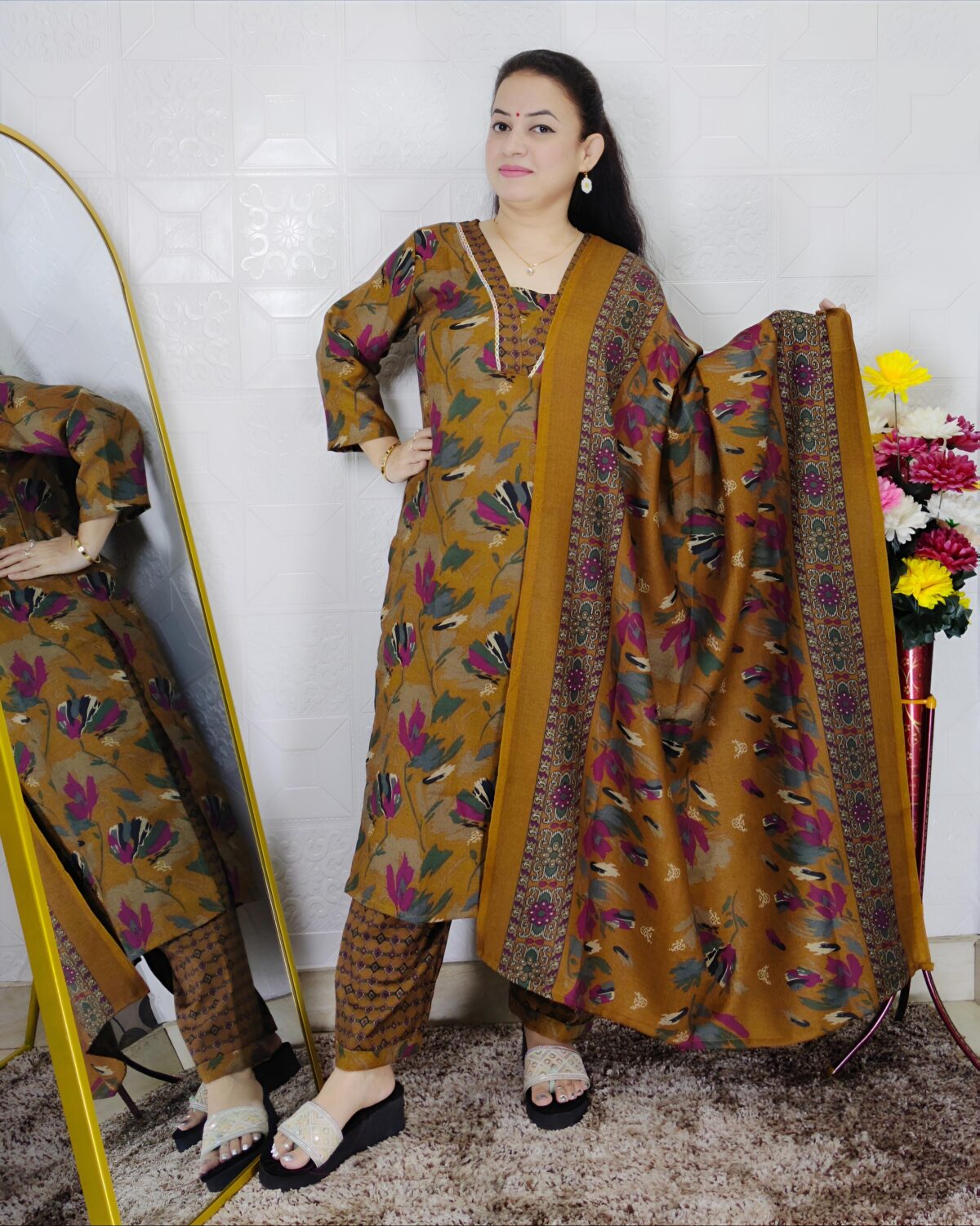 Woman wearing a premium printed pashmina suit with matching dupatta and winter bottom