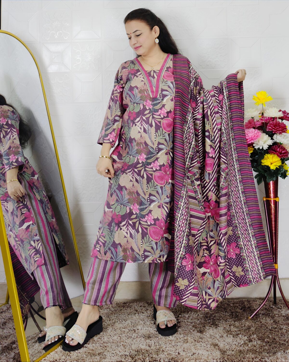 Woman wearing a premium printed pashmina suit with matching dupatta and winter bottom