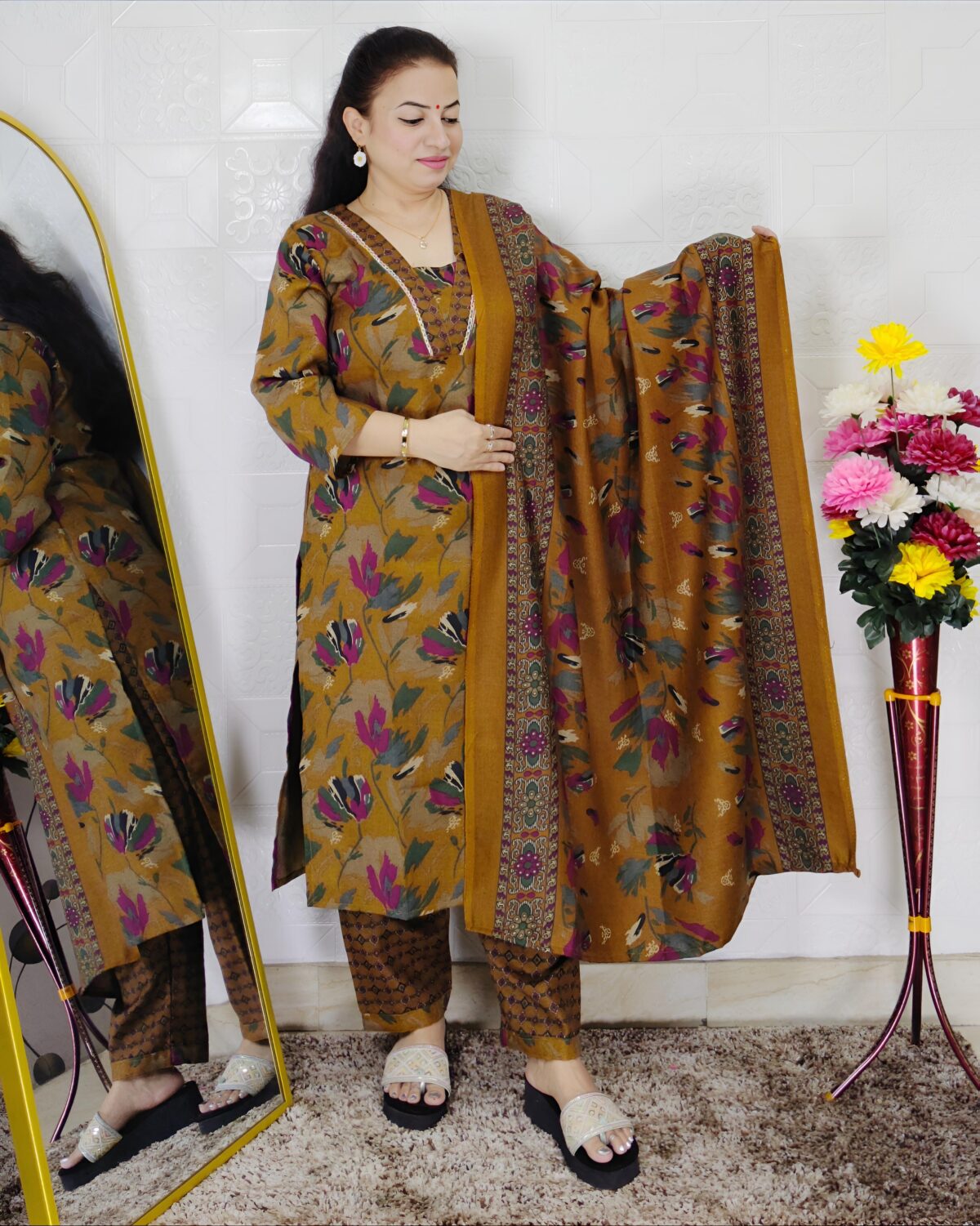 Woman wearing a premium printed pashmina suit with matching dupatta and winter bottom
