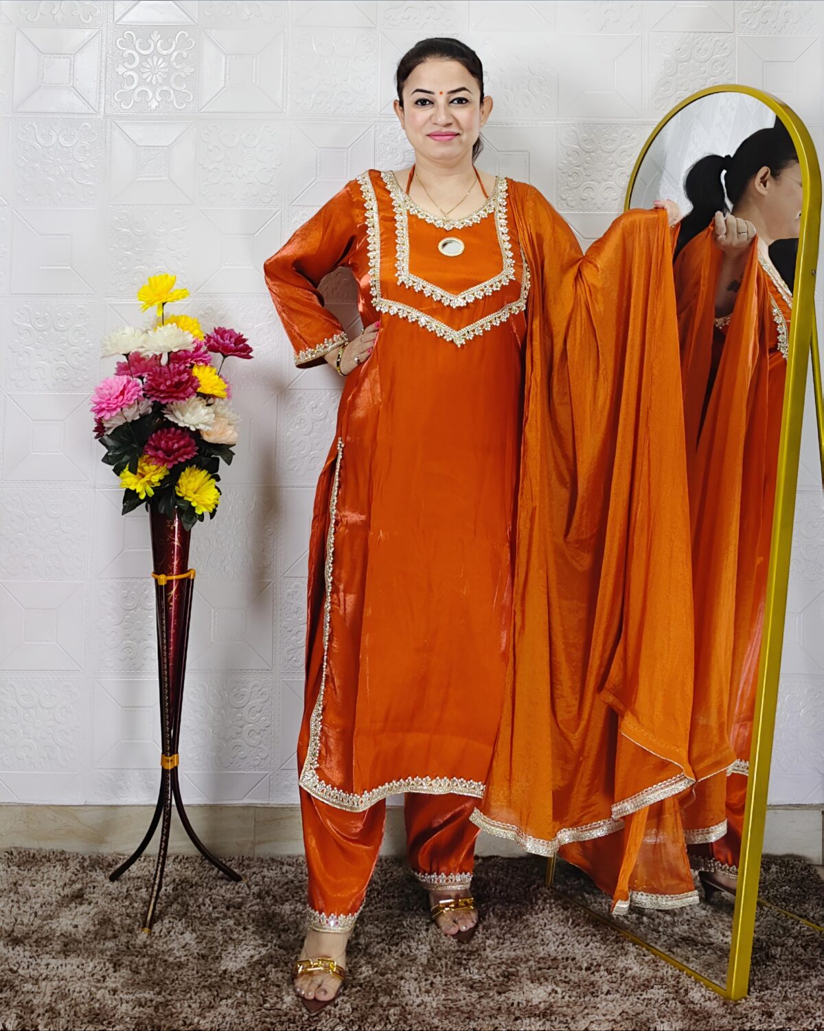 Women wearing orange Roman glass fabric embroidered kurta pant dupatta set ethnic wear suit