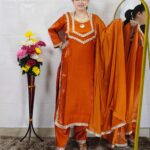 Women wearing orange Roman glass fabric embroidered kurta pant dupatta set ethnic wear suit