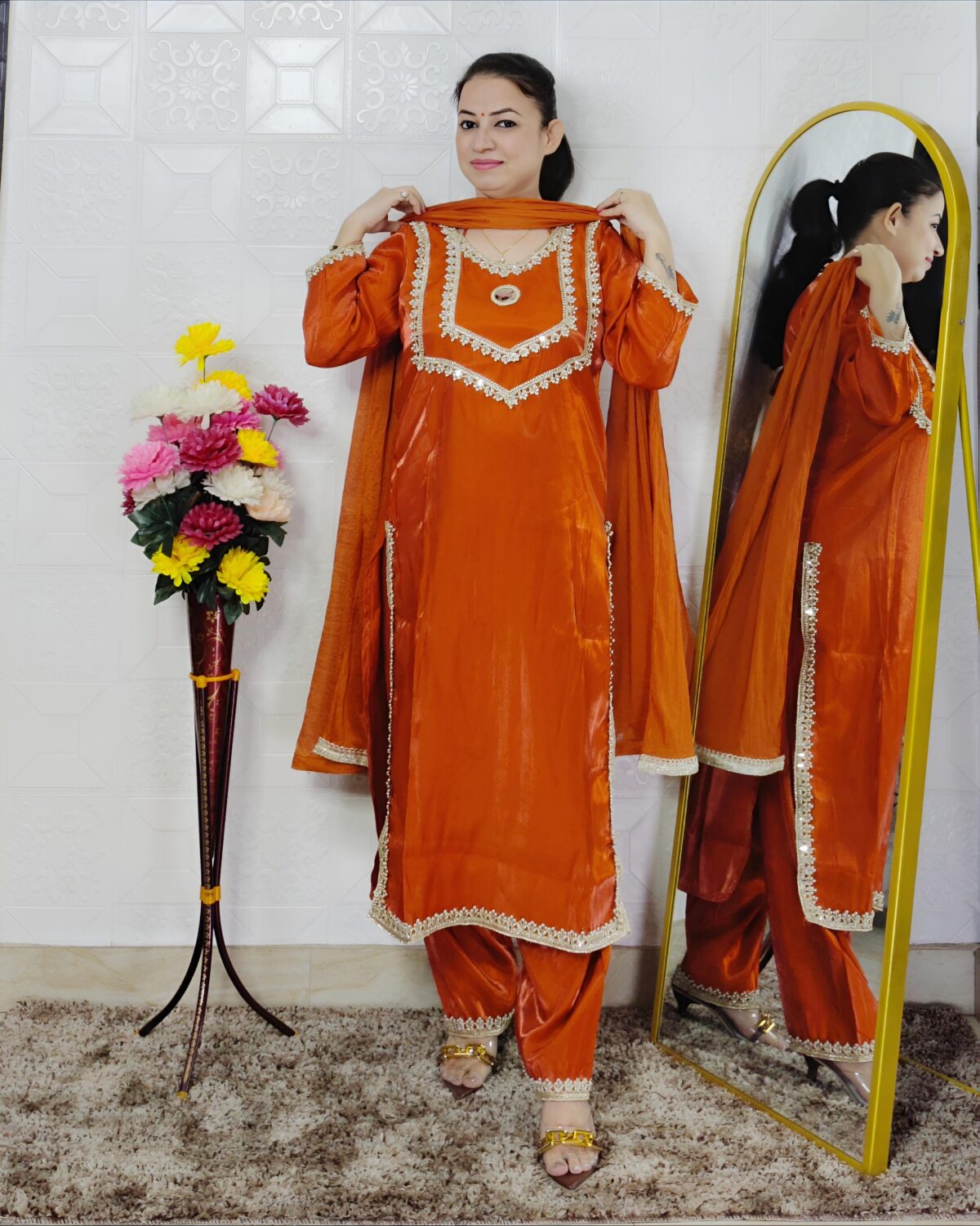 Women wearing orange Roman glass fabric embroidered kurta pant dupatta set ethnic wear suit
