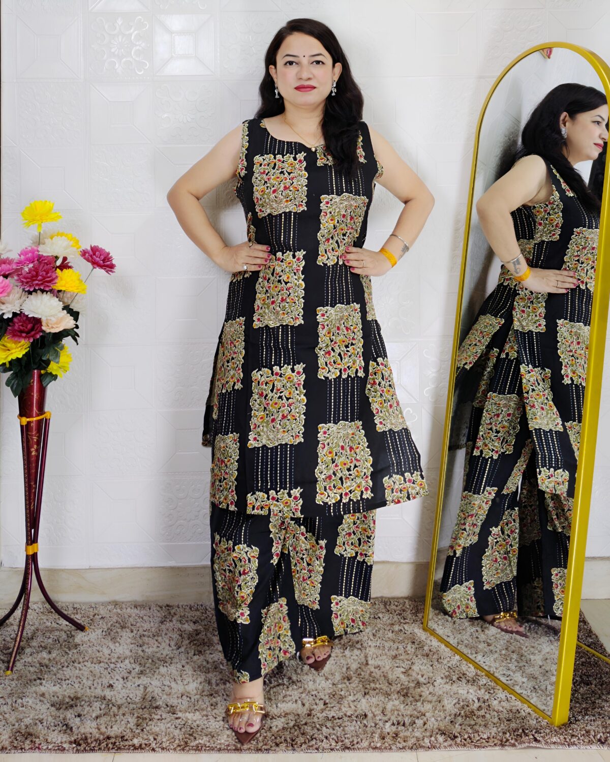 Woman wearing black floral printed cotton co-ord set with sleeveless kurta and matching pants