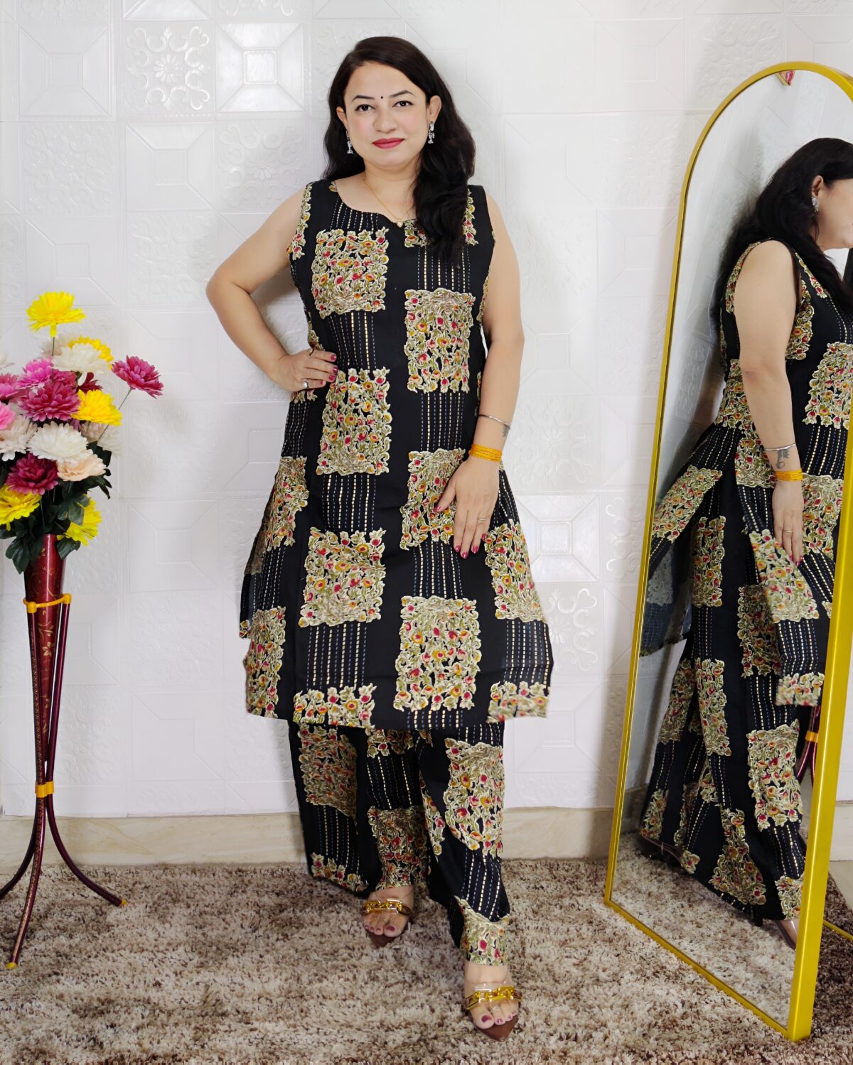 Woman wearing black floral printed cotton co-ord set with sleeveless kurta and matching pants