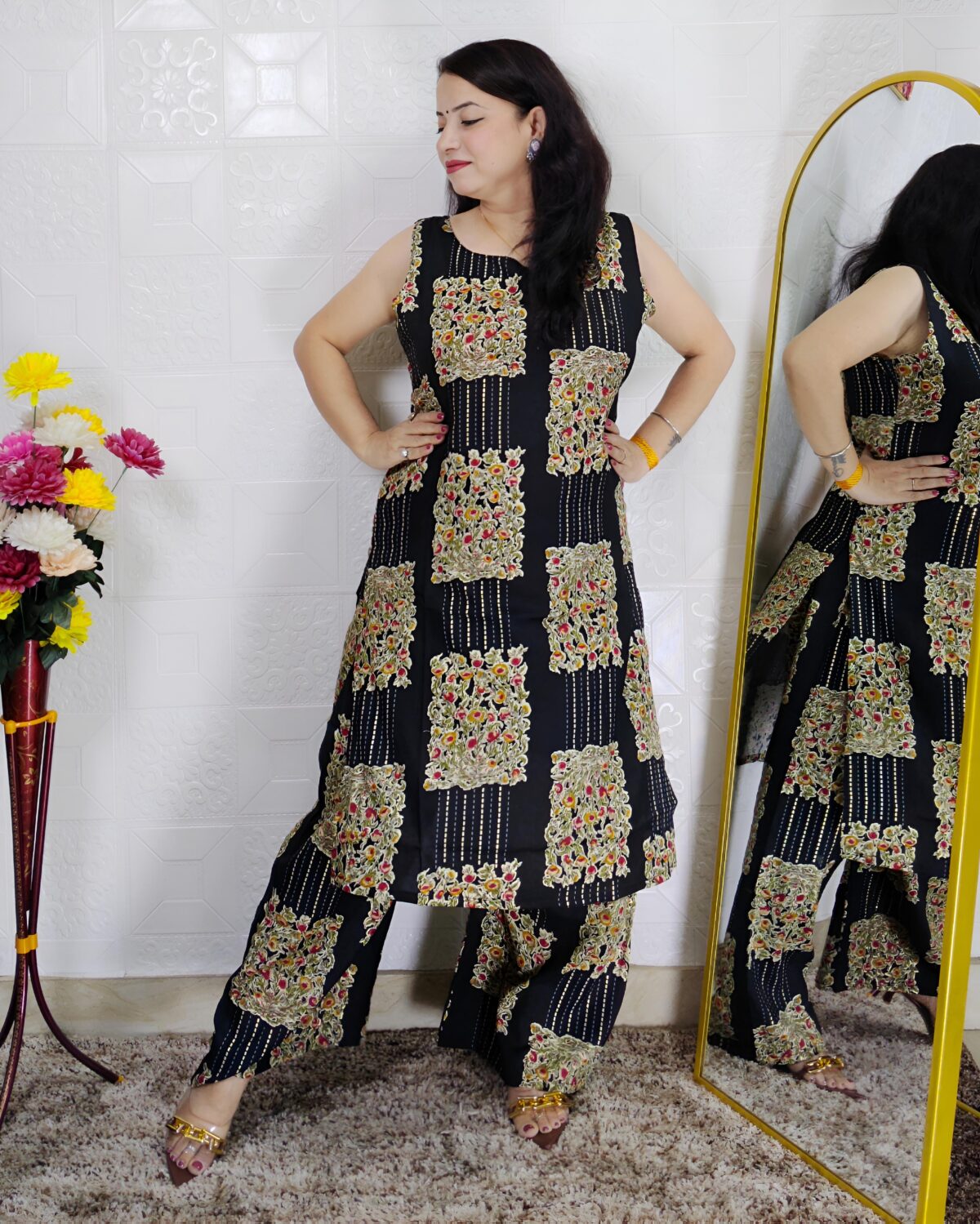 Woman wearing black floral printed cotton co-ord set with sleeveless kurta and matching pants