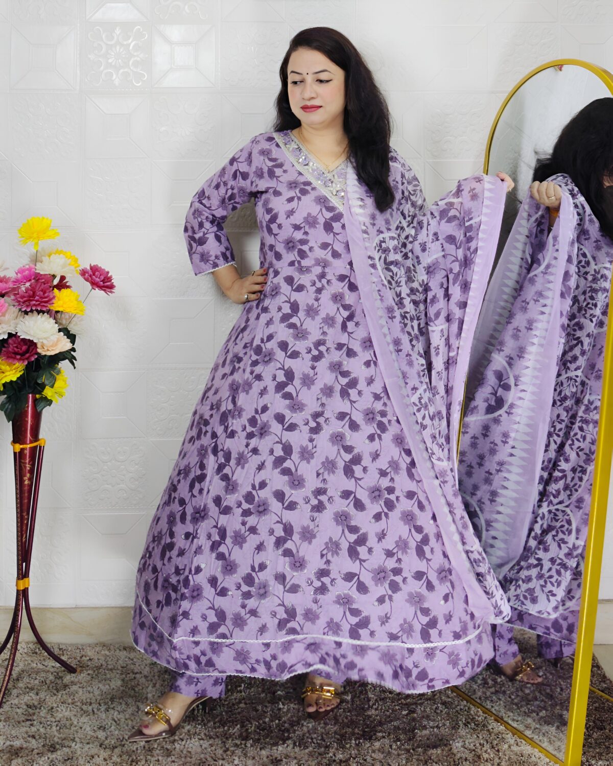 Woman wearing lavender floral printed Anarkali suit set with matching dupatta
