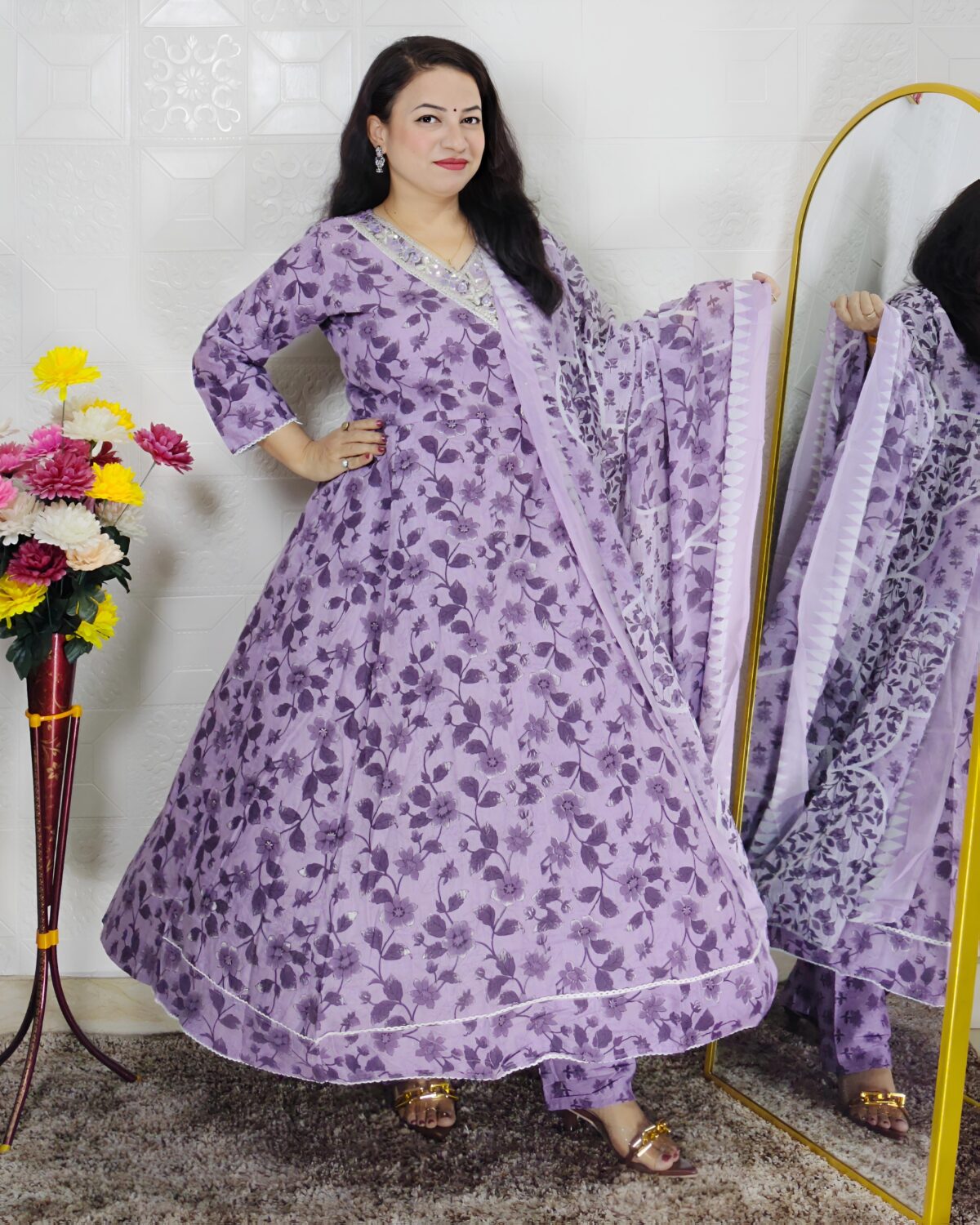 Woman wearing lavender floral printed Anarkali suit set with matching dupatta