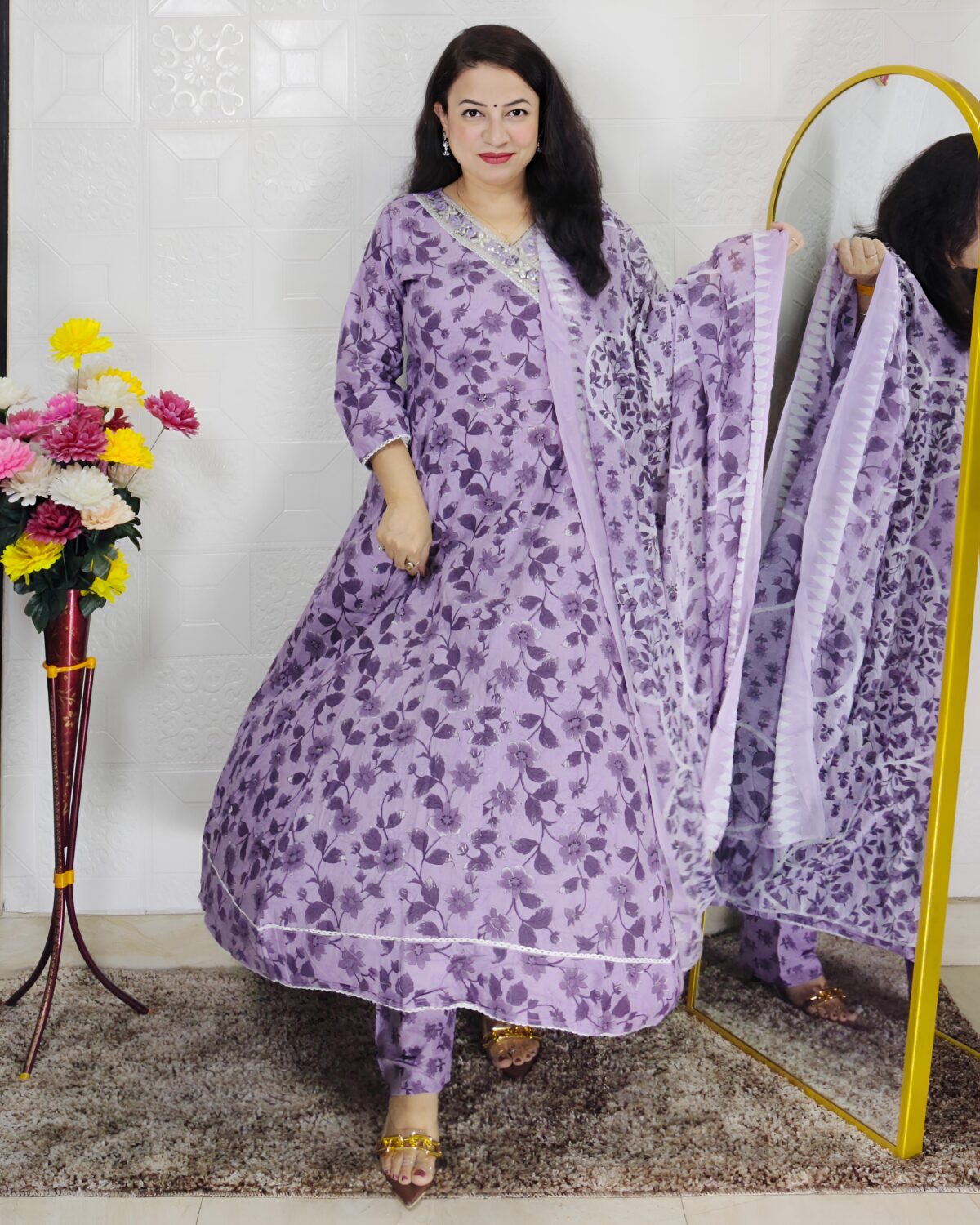 Woman wearing lavender floral printed Anarkali suit set with matching dupatta