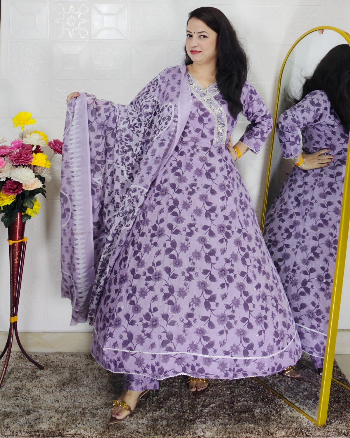 Woman wearing lavender floral printed Anarkali suit set with matching dupatta