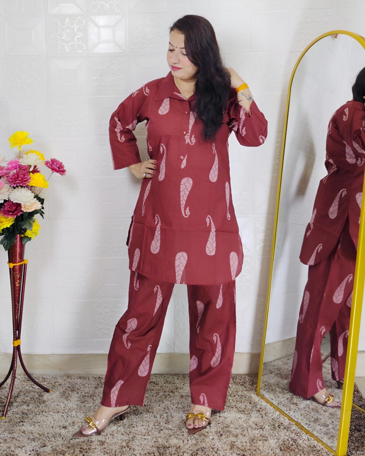 Woman wearing rust printed pure cotton co-ord set with collared top and matching straight-fit pants