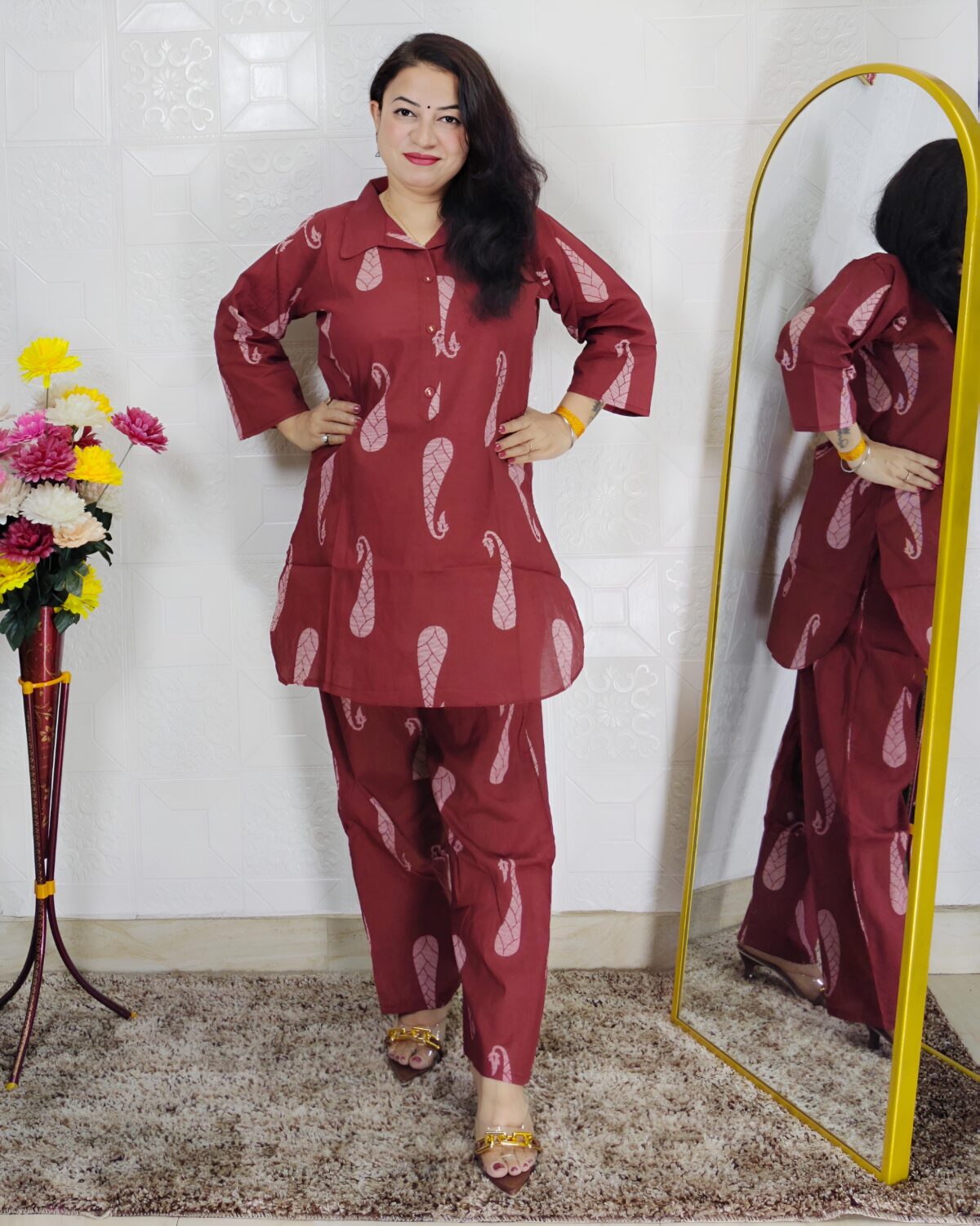 Woman wearing rust printed pure cotton co-ord set with collared top and matching straight-fit pants