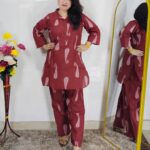 Woman wearing rust printed pure cotton co-ord set with collared top and matching straight-fit pants
