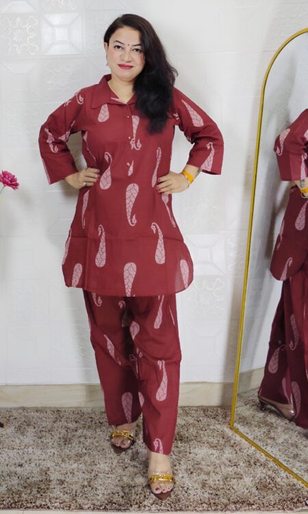 Woman wearing rust printed pure cotton co-ord set with collared top and matching straight-fit pants