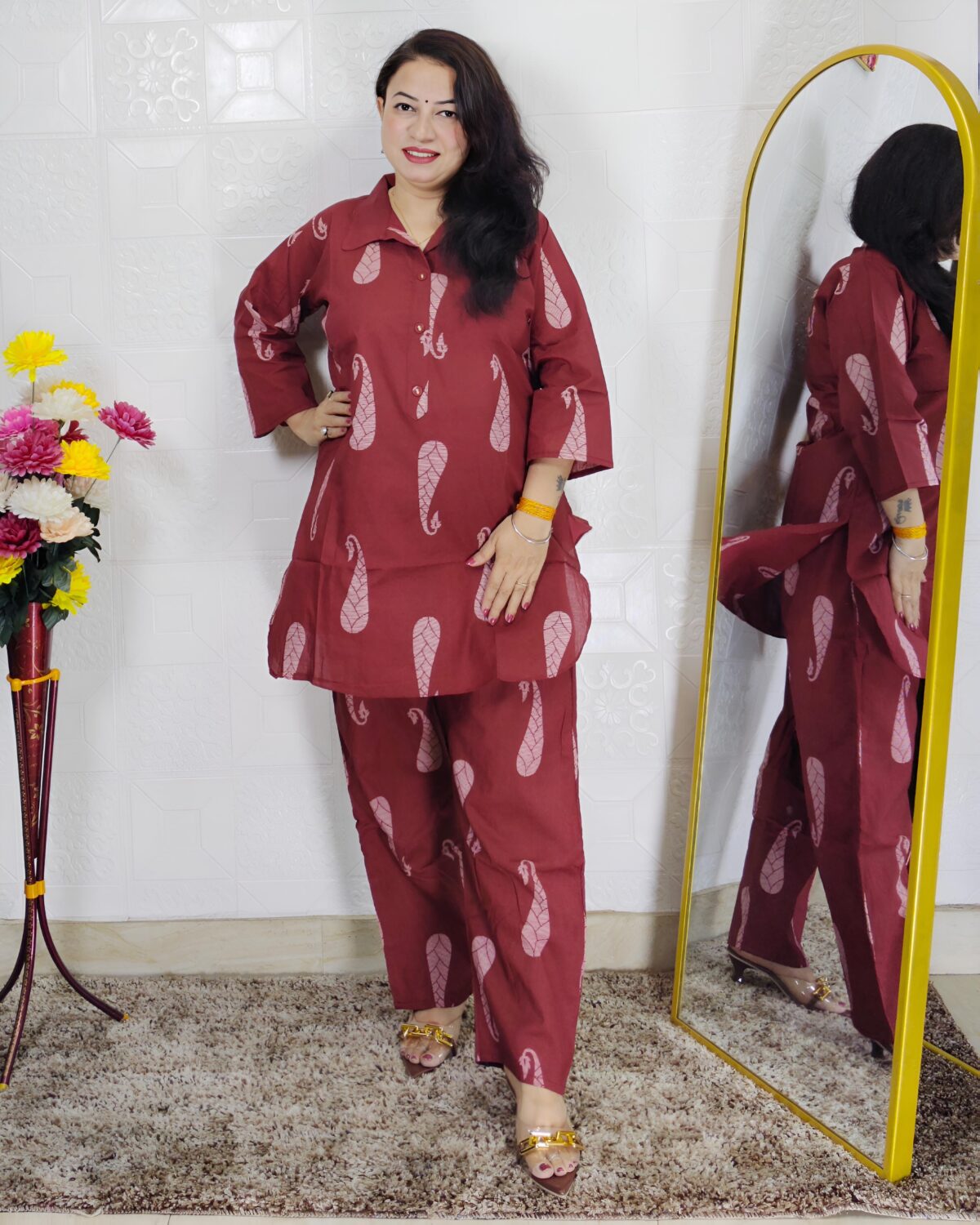 Woman wearing rust printed pure cotton co-ord set with collared top and matching straight-fit pants