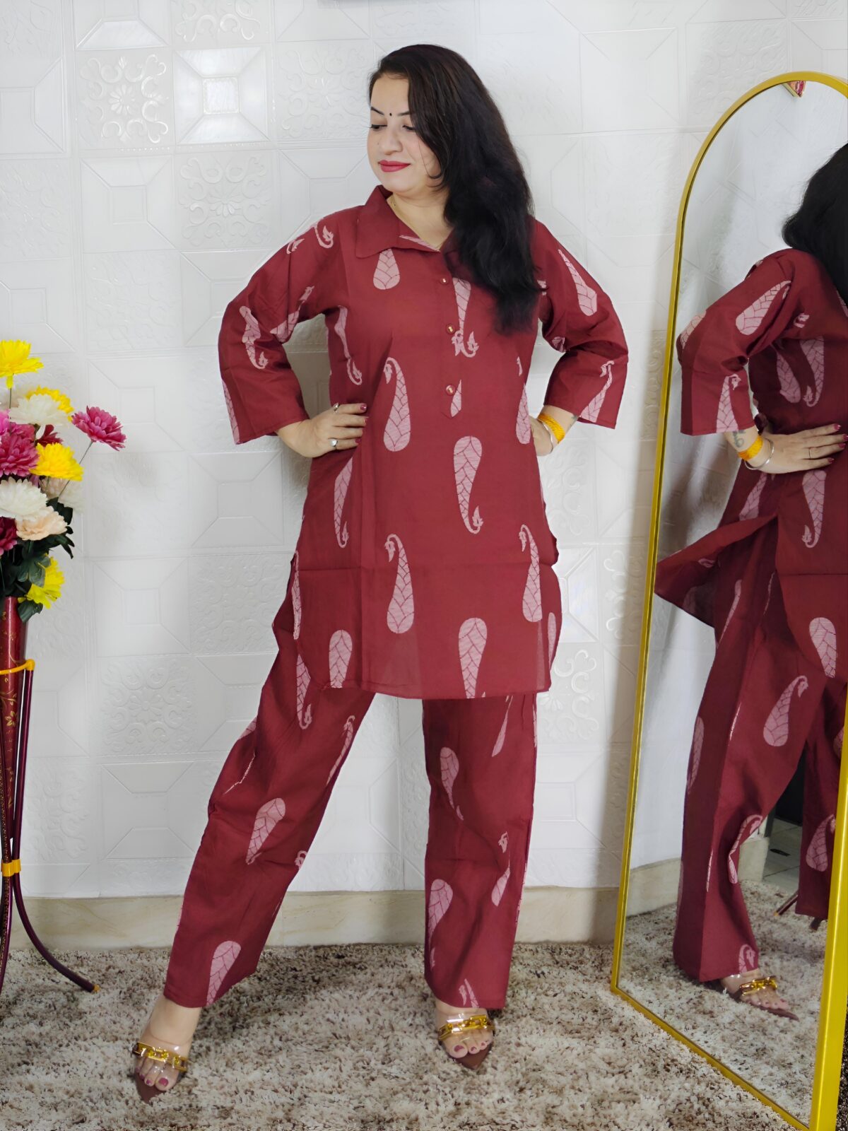 Woman wearing rust printed pure cotton co-ord set with collared top and matching straight-fit pants