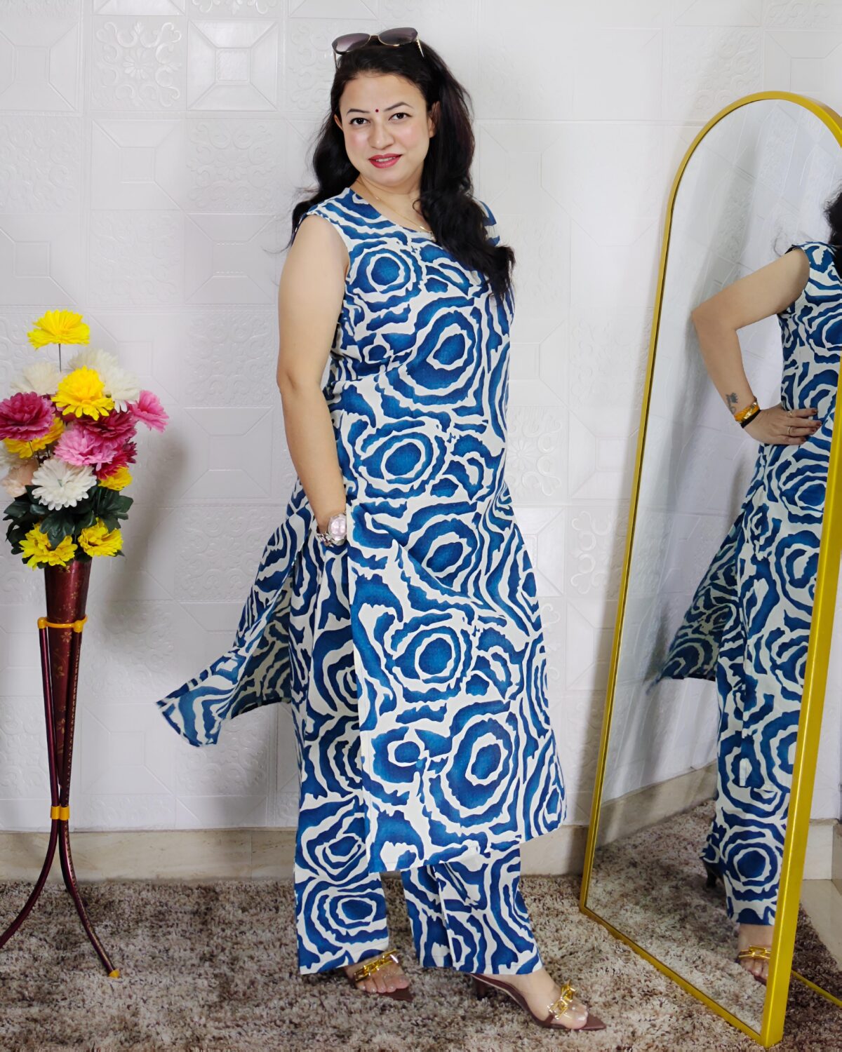 Woman wearing Blue Abstract Printed Cotton Co-Ord Set with Sleeveless Kurta, Wide-Leg Pants and Side Pocket