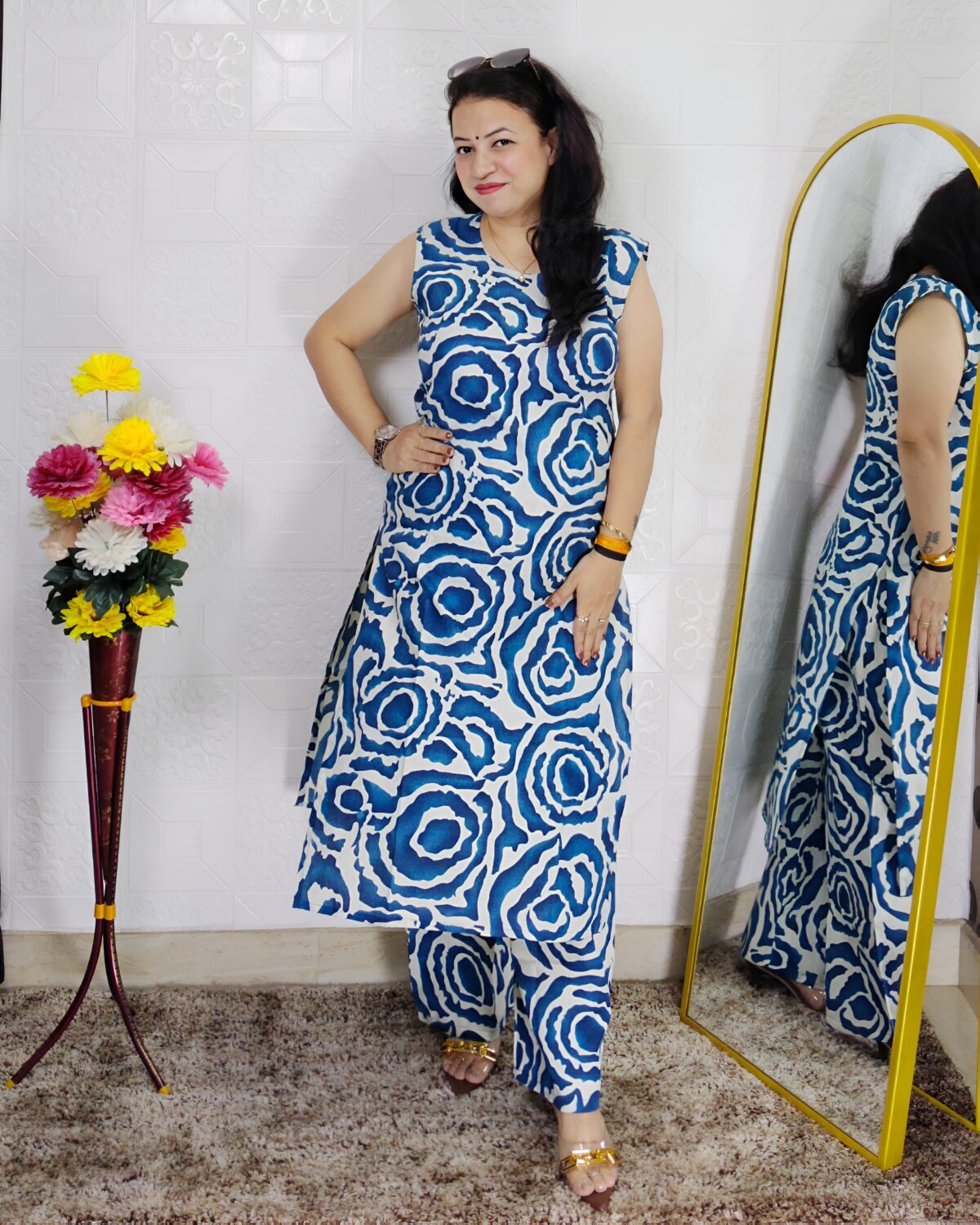 Woman wearing Blue Abstract Printed Cotton Co-Ord Set with Sleeveless Kurta, Wide-Leg Pants and Side Pocket