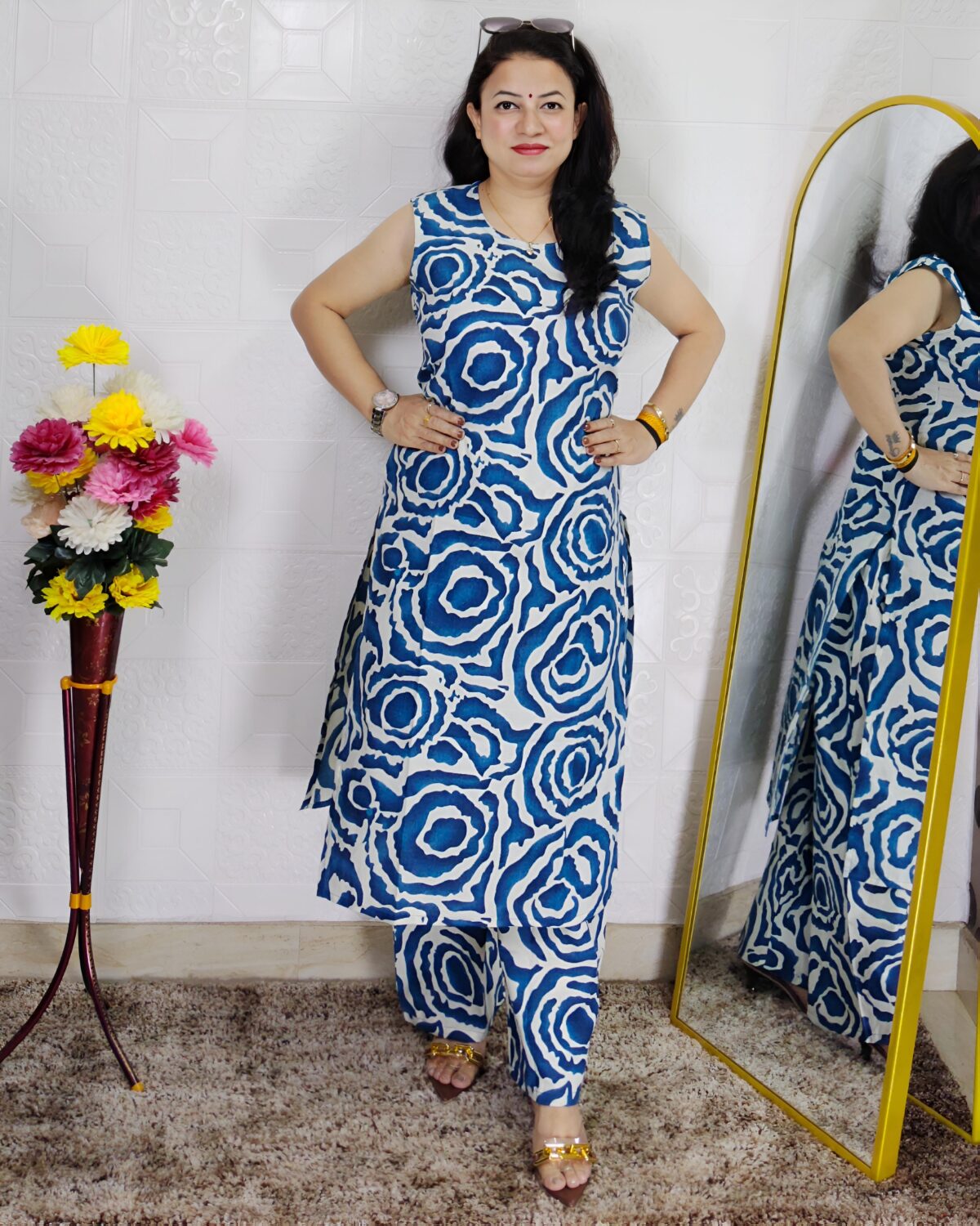 Woman wearing Blue Abstract Printed Cotton Co-Ord Set with Sleeveless Kurta, Wide-Leg Pants and Side Pocket