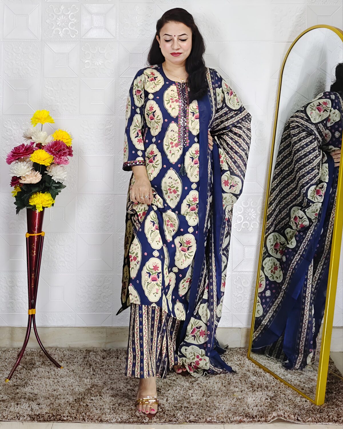 Woman wearing Navy Blue Ajrakh Print Premium Cotton Straight Kurta Suit Set with Printed Palazzo Pants and Matching Cotton Dupatta