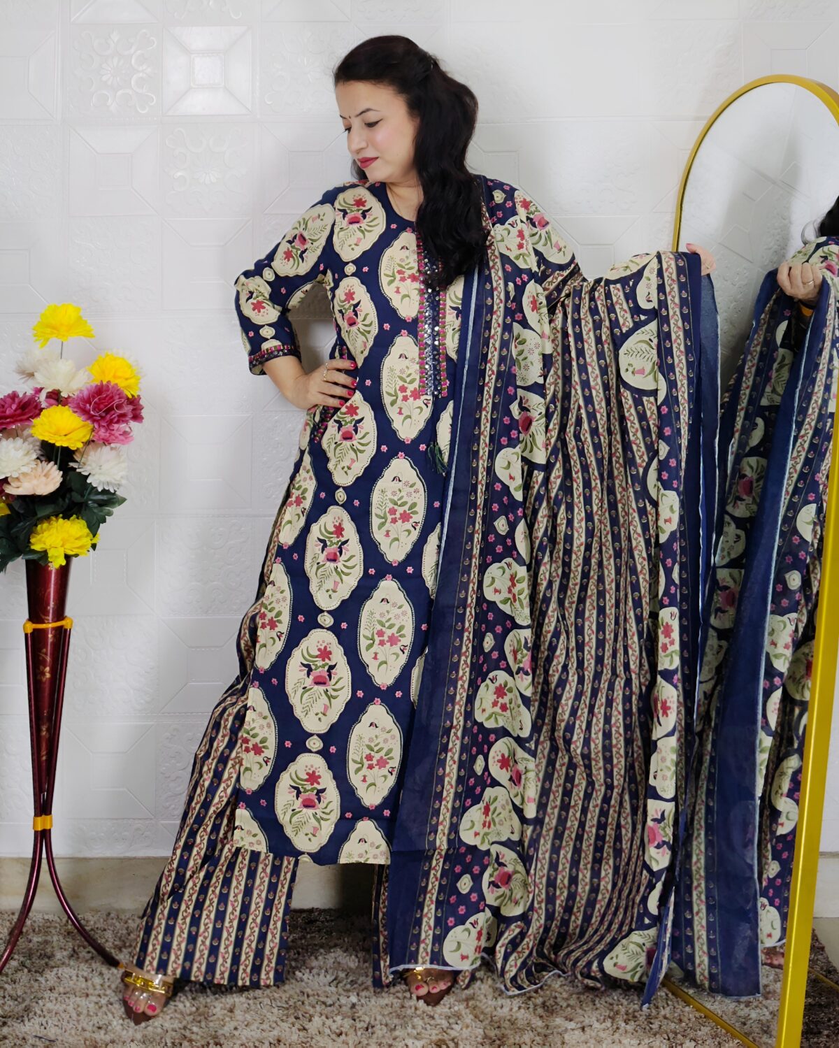 Woman wearing Navy Blue Ajrakh Print Premium Cotton Straight Kurta Suit Set with Printed Palazzo Pants and Matching Cotton Dupatta