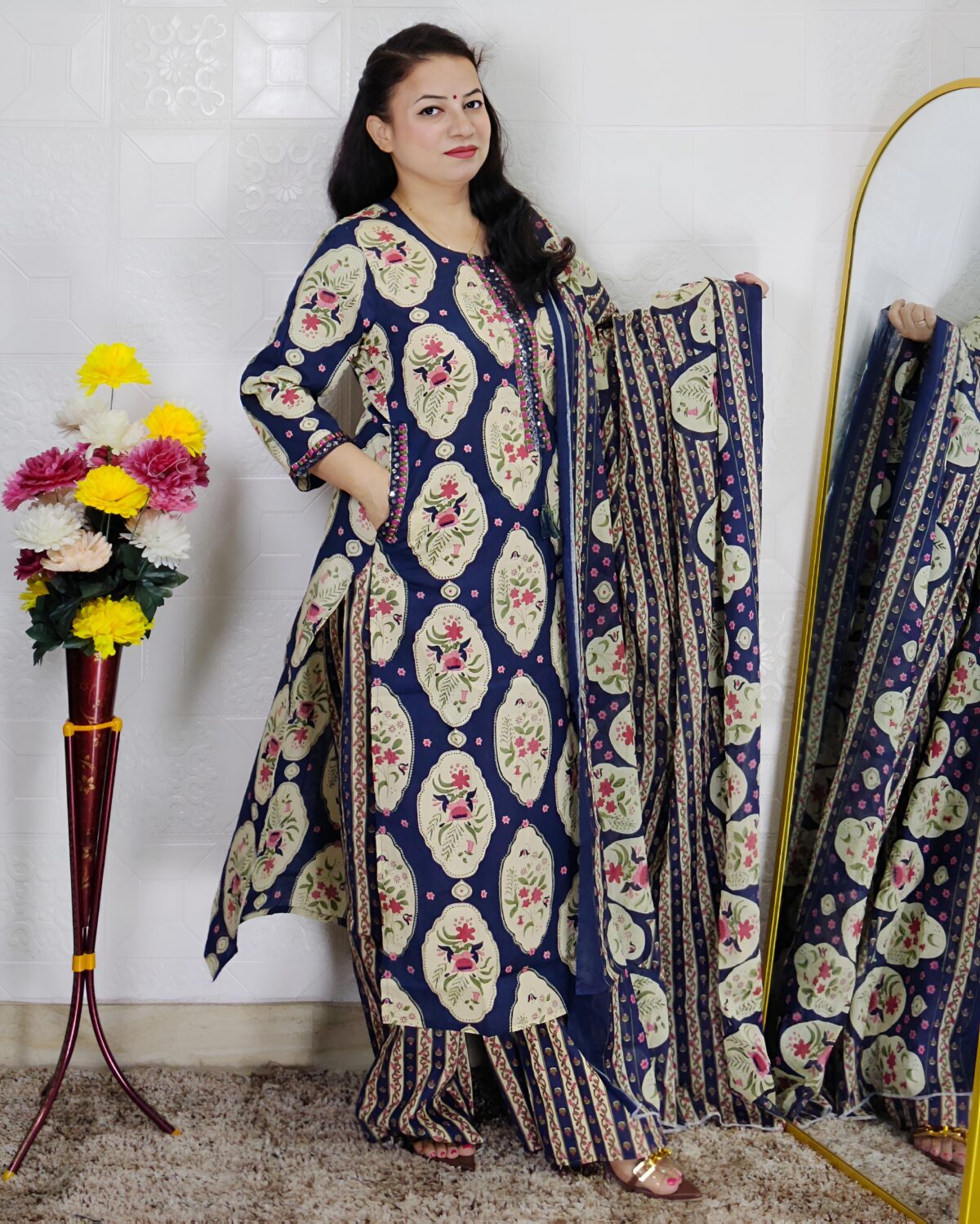 Woman wearing Navy Blue Ajrakh Print Premium Cotton Straight Kurta Suit Set with Printed Palazzo Pants and Matching Cotton Dupatta