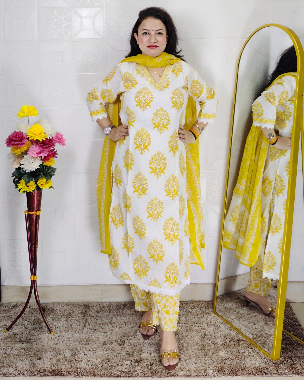 Woman wearing Off White and Yellow Printed Premium Cotton Straight Kurta Suit Set with Inner Lining, Matching Pants and Dupatta