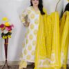 Woman wearing Off White and Yellow Printed Premium Cotton Straight Kurta Suit Set with Inner Lining, Matching Pants and Dupatta